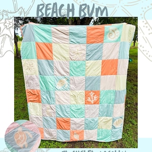 May include: A patchwork quilt with a coastal theme. The quilt features squares in shades of orange, blue, green, and cream. Some squares have seashell, turtle, and coral designs. The text "BEACH BUM" is at the top, and "BY: SHELBY MCCOLLUM" is at the bottom.