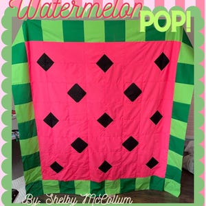 May include: A watermelon-themed quilt with a pink center, black diamond shapes, and green striped edges. The quilt has the words "Watermelon POP!" and "By Shelby McCollum" in a decorative font.