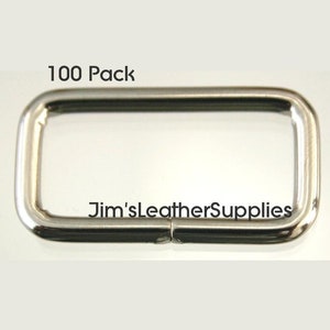 A pack of 100 1 inch nickel plated steel belt keepers or loops.