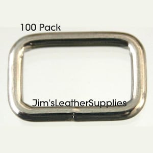 May include: A pack of 100 silver metal D-rings. The rings are rectangular in shape and have a smooth finish.  The text "Jim'sLeatherSupplies" is visible on the ring.  100 Pack