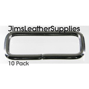 May include: A pack of 10 silver metal D-rings, each measuring approximately 1 inch in length.  The D-rings are shown against a white background.  The text "JimsLeatherSupplies" and "10 Pack" are visible in the image.