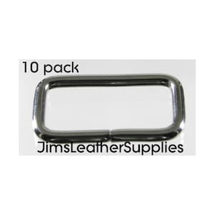 May include: A pack of 10 silver metal D-rings. The D-rings are rectangular in shape and have a smooth finish.  The text "10 pack" and "JimsLeatherSupplies" is visible in the image.
