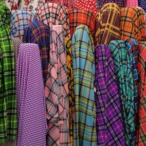 May include: A variety of plaid fabrics in different colors, including green, purple, blue, pink, and red.