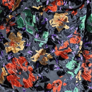 May include: Black sheer fabric with a velvet floral pattern in shades of red, orange, green, and purple.