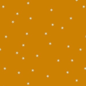 May include: A seamless pattern with white snowflakes on a mustard yellow background.