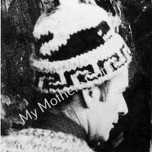May include: A black and white knitted hat with a patterned design. The hat features a pom-pom and a decorative band. The text "My Mother's Friend" is visible on the hat.