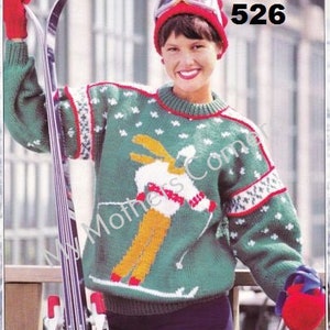 May include: A green, white, and red knitted sweater with a skier design. The sweater has a white snowflake pattern and a red and white trim. The number 526 is printed on the image.
