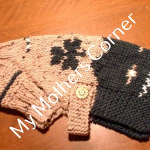 May include: A knitted dog sweater with a pink and gray color scheme. The sweater has a button closure and a white trim. The sweater has a pattern of four-leaf clovers.