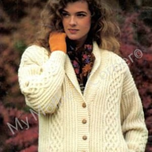 May include: A cream-colored knitted cardigan with a cable knit pattern and a shawl collar. The cardigan has a button closure and long sleeves.