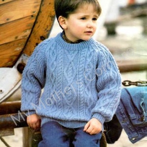 May include: A blue knitted sweater with a cable knit pattern. The sweater has a round neckline and long sleeves.