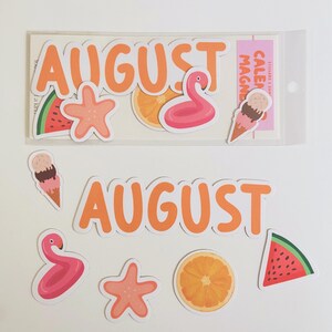 May include: A set of summer-themed stickers and magnets featuring the word AUGUST in orange letters, a pink flamingo pool float, a peach starfish, a slice of watermelon, an orange slice, and a double-scoop ice cream cone on a white background.