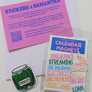 May include: A pink thank you card with blue text, a clear plastic bag containing calendar magnets with various labels like Insurance, Streaming, and Pay Day, and a separate sticker of a jar of green pickles with the text Pickles.