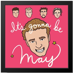 May include: A pink and black framed print with a cartoon illustration of a man with brown hair and a big smile. The text "It's gonna be May" is written in white cursive lettering with two yellow stars. Five cartoon faces of men are in the top row of the print.
