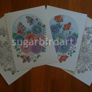 May include: Four coloring pages featuring a detailed illustration of a bouquet of flowers with butterflies. The pages are in various stages of completion, with one page completely blank, one page with black ink outlines, and two pages with colored flowers and butterflies.