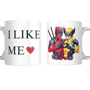 May include: White ceramic mug with a red heart and the text "I LIKE ME" on one side and a cartoon image of Deadpool and Wolverine on the other side.