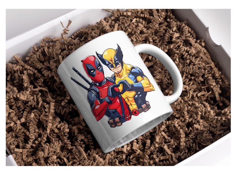May include: White ceramic mug with a graphic of Deadpool and Wolverine, both characters are depicted with their signature poses and colors. The mug has a black handle.