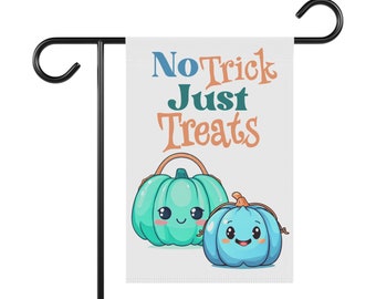 May include: A white garden flag with the text "No Trick Just Treats" in blue and orange lettering. Two cartoon pumpkins with smiling faces are on the bottom of the flag. The pumpkins are teal and blue.