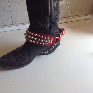Single three row studded bootstrap on red leather