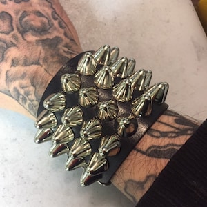 Four row tall cone studded bracelet