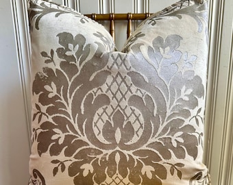 May include: A white pillow with a brown damask pattern. The pillow is made of a soft, luxurious fabric and has a subtle sheen.