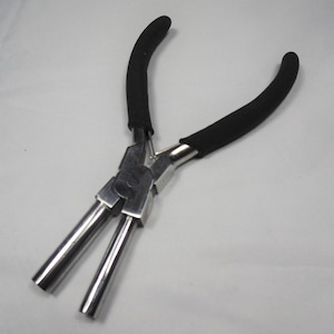 May include: Black handled pliers with two long, silver, metal jaws. The pliers are designed for closing jump rings.