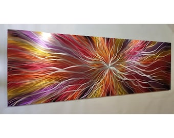 May include: A rectangular metal wall art piece featuring a vibrant, multi-colored abstract design. The surface displays sweeping, curved lines in shades of red, orange, yellow, and purple, radiating outward from a central point with a metallic finish.