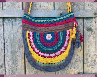 May include: A colorful crocheted shoulder bag with a round, multi-colored design. The bag has a long strap and tassels.