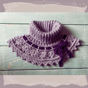 May include: A crocheted cowl with a purple bow. The cowl is made of a light purple yarn and has a scalloped edge. The bow is made of a darker purple yarn.