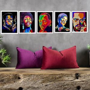 May include: Five framed portraits of famous African Americans in a colorful, abstract style. The portraits are displayed on a wall with a wooden bench in front of them.