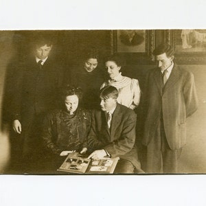 Looking at pictures, antique rppc photo