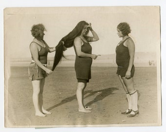 Proud of her long hair, vintage press photo