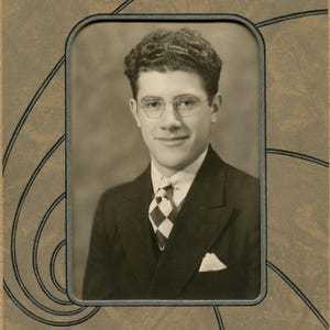May include: Sepia-toned portrait of a man in a suit and tie, framed within a decorative border. The man wears glasses and a patterned tie. The suit has a pocket square. The image has a vintage aesthetic.