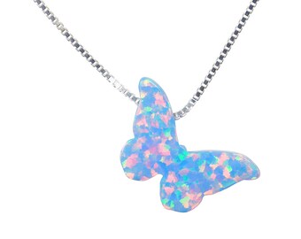 May include: A silver chain necklace with a blue opal butterfly pendant. The butterfly has a iridescent finish with pink and green highlights.