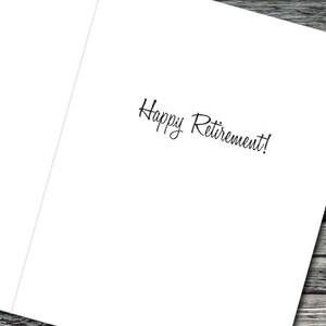 May include: A white card with the text "Happy Retirement!" written in black cursive.