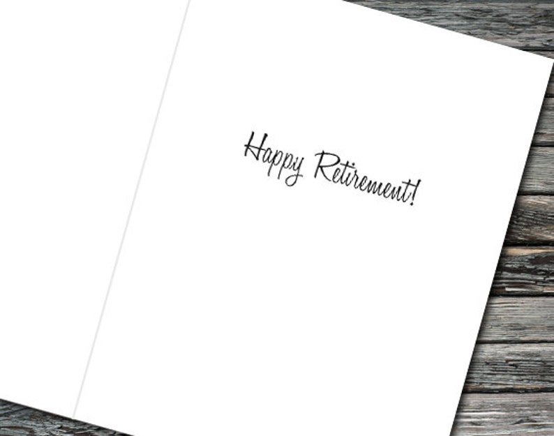 May include: A white card with the text "Happy Retirement!" written in black cursive.