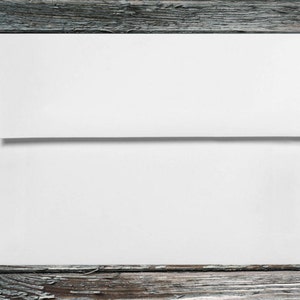 May include: A white envelope on a weathered wooden background.