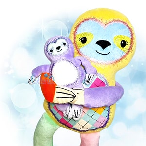 May include: A yellow and blue sloth plush toy holding a smaller purple sloth plush toy. The larger sloth has a heart-shaped face with embroidered eyes and a smile. The smaller sloth has a simple face with embroidered eyes and a smile. Both sloths have a patchwork design with different colors and patterns.