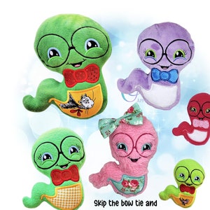 May include: A collection of plush worm-like creatures, each with round glasses and a smiling face. The worms are in various colors, including green, purple, pink, and red, and feature bow ties or hair bows. Some have aprons with illustrations. Text reads: "Skip the bow tie and add a hairbow for another look!"