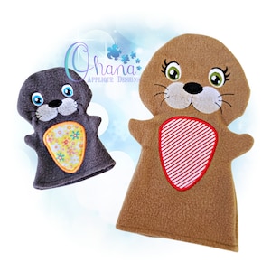 May include: Two plush hand puppets, one brown and one gray, with embroidered faces and details. Both puppets have a heart-shaped patch on their chest, one with a floral pattern and the other with red and white stripes.