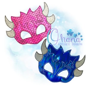 May include: Two dragon masks, one pink and one blue, with silver horns and eye holes. The masks are made of felt and have a scaly texture.