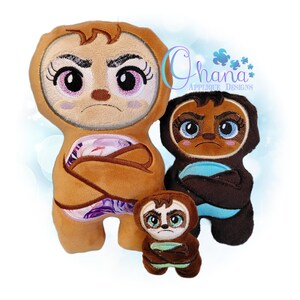 May include: Three plush sloth toys in different sizes, featuring embroidered faces with large eyes, furrowed brows, and crossed arms. The largest is tan with a floral belly, the medium is dark brown with a blue belly, and the smallest is brown with a light green belly.