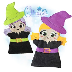 May include: Two felt witch finger puppets with different colored hats and hair. The witch on the left has a green hat and purple hair, while the witch on the right has a purple hat and blonde hair. Both witches have black dresses with a contrasting colored belt.