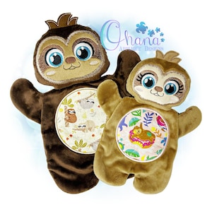 May include: Two plush brown sloth puppets with embroidered faces and large eyes. The larger sloth has a circular patch with a sloth design on its chest. The smaller sloth has a circular patch with a sloth on a donut design on its chest.