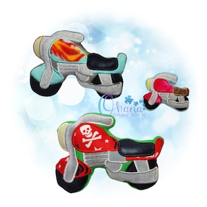 May include: Three plush toy motorcycles in different colours and designs. The largest motorcycle is teal with orange and yellow flames, the middle motorcycle is green with a skull and crossbones, and the smallest motorcycle is red.