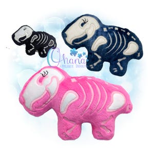 May include: Three plush dinosaur toys in black, blue, and pink, each featuring a white skeleton design. The toys are soft and cuddly, with embroidered details. The toys are in different sizes.