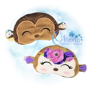 May include: Two plush monkey sleep masks. One mask is brown with colourful polka dot ears. The other mask is white with pink flowers and purple polka dot ears. Both masks have embroidered eyes and a smiling mouth.