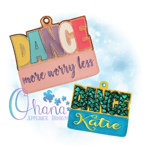 May include: Two colorful embroidered patches with the word "Dance" in large letters. The top patch is pink with the text "more worry less" below the word "Dance". The bottom patch is blue with a green sparkly mermaid scale design and the name "Katie" below the word "Dance".