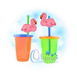 May include: Two clear plastic cups with lids and straws. Each straw has a pink flamingo charm attached. The cups are orange and green.