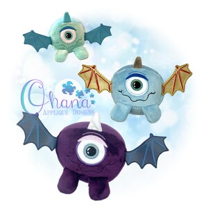 May include: Three plush toys shaped like monsters with one large eye, horns, and wings. The monsters are purple, blue, and green.