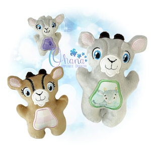 May include: Three plush toy goats, one brown, one gray, and one light gray. The gray goat has a green patch with a smaller gray goat inside. The brown goat has a pink and white checkered patch. The light gray goat has a purple patch.